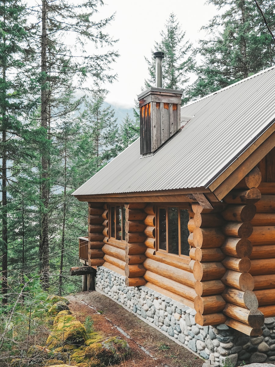 brown wooden house surrounded by green trees during daytime